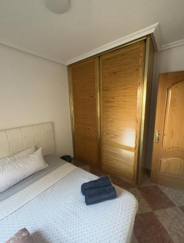 a bedroom with a bed with a blue bag on it at El Gengo Suite in Madrid