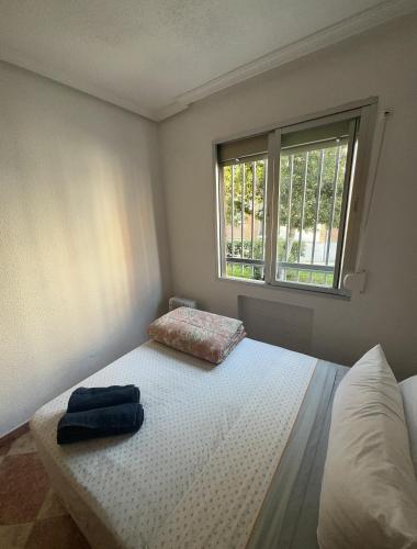 a bedroom with a bed and a window at El Gengo Suite in Madrid