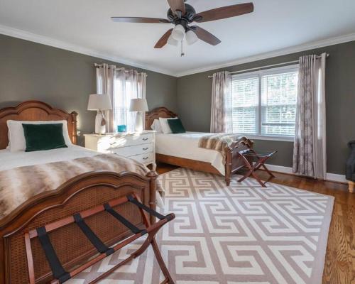 a bedroom with two beds and a ceiling fan at Fernwood Manor in High Point