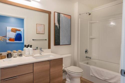 a bathroom with a sink and a toilet and a tub at Uw Tacomahospitalslocal Govportking Bed4k Tv in Tacoma