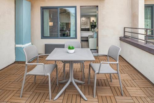 a white table and chairs on a balcony at Yosemite Southgate Hotel & Suites in Oakhurst