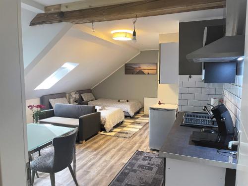 a room with a kitchen and a living room at Apartments Pellinger-Hof in Pellingen