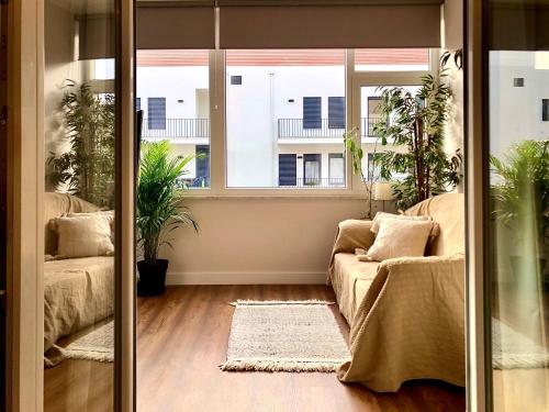 a living room with a couch and a window at Modern City Center Apartment in Torres Vedras