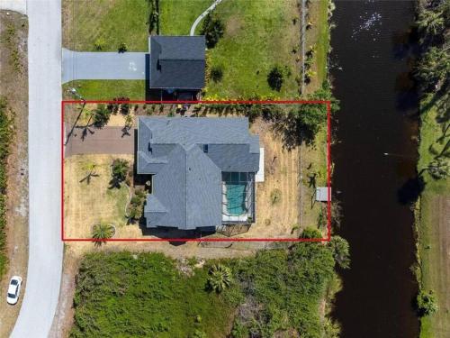 an aerial view of a house next to a body of water at Seabreeze 3-Bedroom Pool Villa close to the beach!!! in Port Charlotte