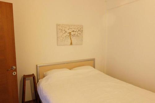 a bedroom with a bed and a picture on the wall at GENI Apartment - Center Of Fethiye Close to the Beach Fast Wi-Fi Netflix in Fethiye