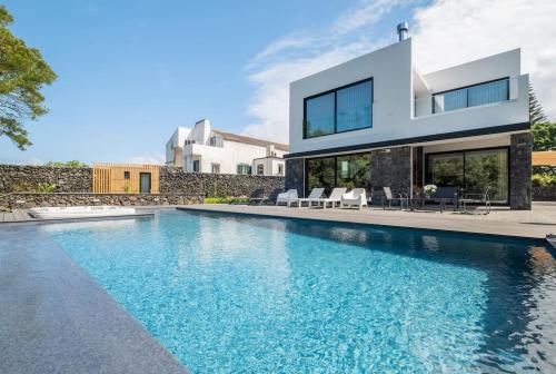 an image of a swimming pool in a house at Lotus House - Heated Pool & Jacuzzi near the Beach in Ponta Delgada