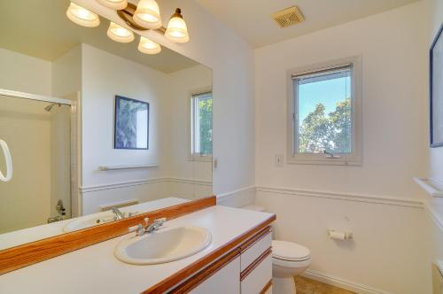 a bathroom with a sink and a toilet and a mirror at Epic Sandy Home with Heated Pool and Mountain Views! in Sandy