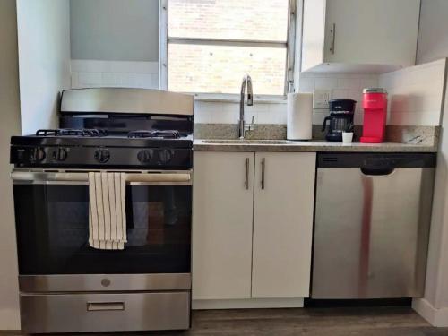 a kitchen with a stove and a sink at Cozy 1BDR In Center City Philly Hosted By StayRafa in Philadelphia