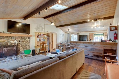 a living room with a large couch and a stone fireplace at 3 Mi to Heavenly Mountain Resort Home with Deck in Stateline
