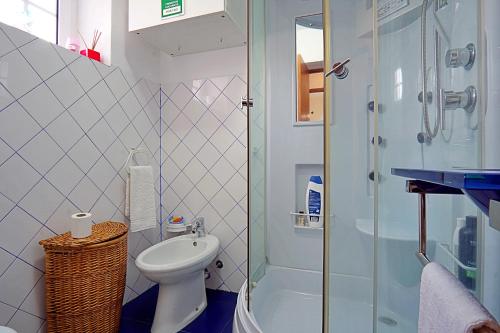 a bathroom with a shower and a toilet and a sink at Casa dos Plátanos near the center of Amarante, Golf Course and Water Park. in Amarante