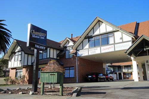 a building with a sign in front of it at Champers Motor Inn in Lower Hutt