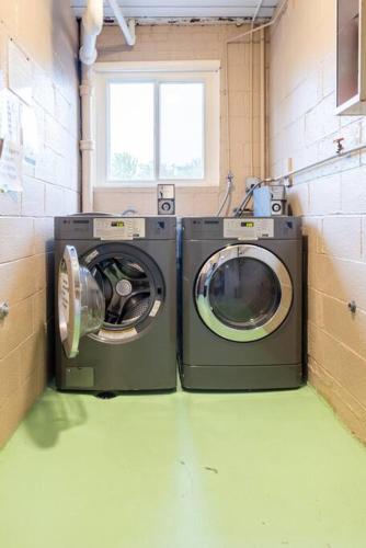two washing machines in a laundry room with a window at King & Queen First Floor Unit! 1-2c Georgetown Villas in Fairview Park