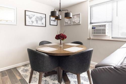 a dining room table with chairs and a vase of flowers at King & Queen First Floor Unit! 1-2c Georgetown Villas in Fairview Park