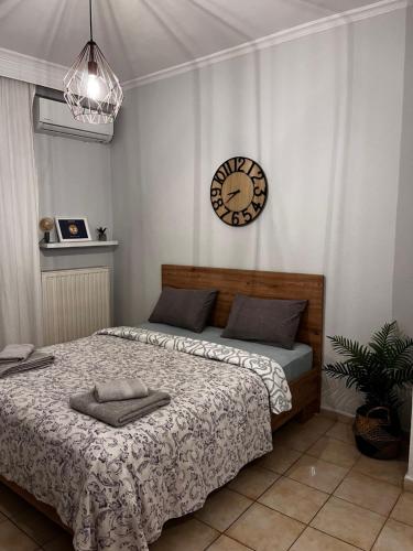 a bedroom with a bed and a clock on the wall at Nikoletta's home in Komotini
