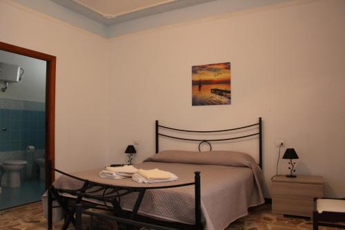 阿爾蓋羅的住宿－Alghero Budget Automated check in，一间卧室配有一张床、一张桌子和一张图片