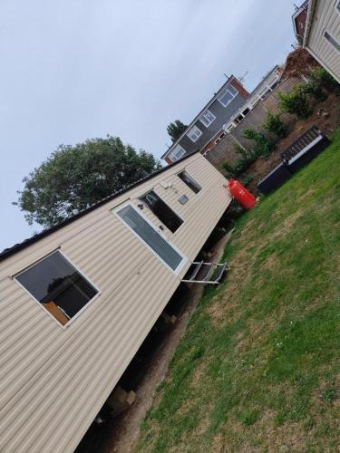 a house with two windows on the side of it at H9 Fairway Holiday Park Sandown in Sandown
