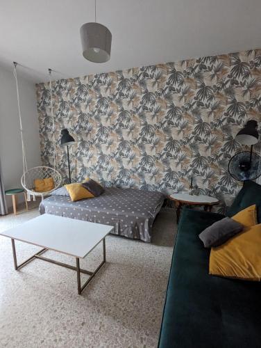 a living room with a couch and a table at Fly Dodo Summer Residence in Marsaskala