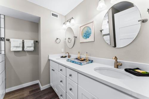 a bathroom with a sink and a mirror at Fanta-Sea 55 in Siesta Key