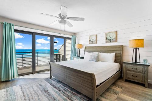 a bedroom with a bed and a view of the ocean at Fanta-Sea 55 in Siesta Key