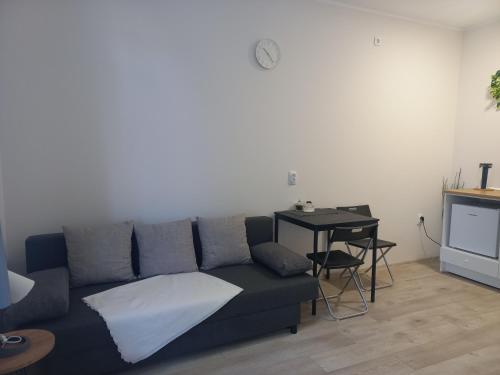a living room with a couch and a table at KOD VELIKIH TUJA in Melenci