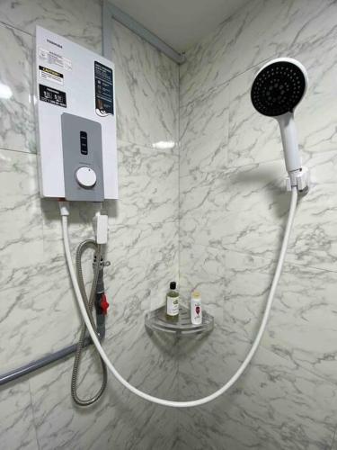 a shower in a bathroom with a hair dryer at C0ZY Space for Work and Relax in Kuala Lumpur