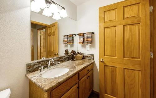 a bathroom with a sink and a large mirror at New Listing! Woodland Heights at Tahoe Park- Pet Friendly - Private Beach in Tahoe City