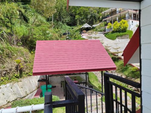a red roof on top of a balcony at KUNDASANG MOUNT GARDEN in Kundasang