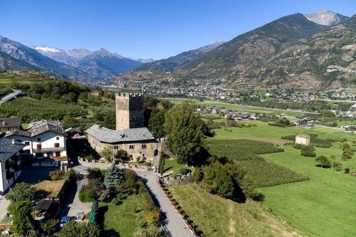 an aerial view of a village with mountains in the background at B&B La Tour de Villa in Aosta