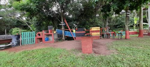 a playground in a park with colorful equipment at Habitación Familiar. El Arroyo in Paraguarí