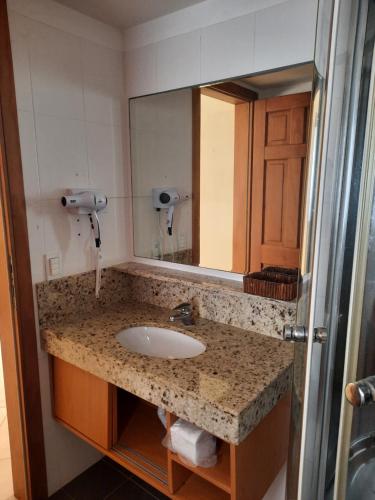 a bathroom with a sink and a mirror at Apartamento 320 Praia Bonita Resort in Nísia Floresta