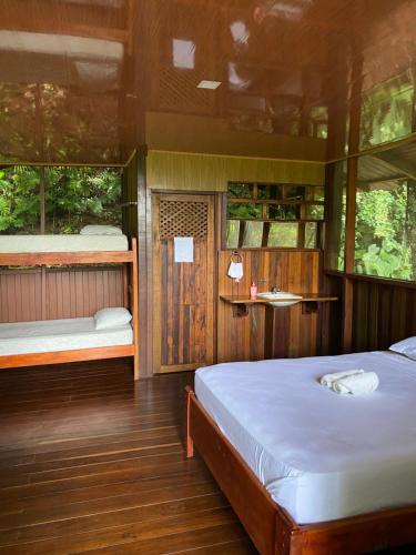 a bedroom with two beds and two windows at Finca la Bonita, Playa Carate in Carate