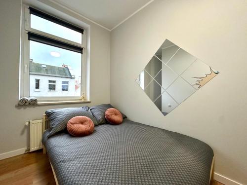 a bedroom with a bed with two pillows on it at MMRent Spidey Room in Gdańsk
