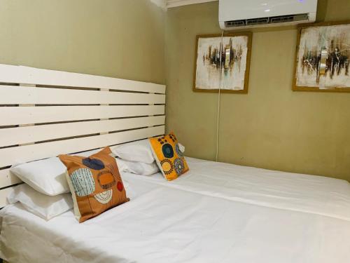 a bedroom with two beds with pillows on them at SURVIVOR GUEST HOUSE-Giyani in Giyani