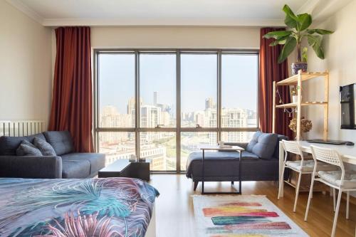a bedroom with a bed and a living room with a large window at Your Bright-Cozy&Luxury home Istanbul in Istanbul