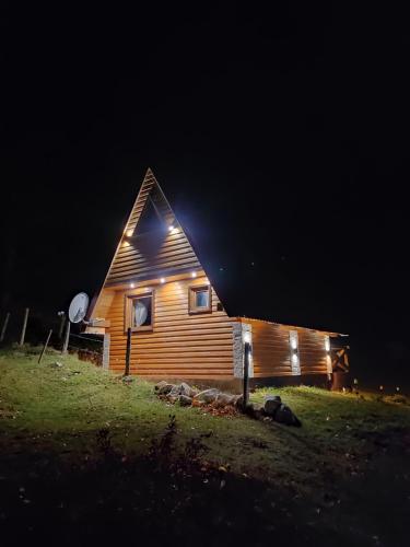 a wooden cabin at night with lights on it at Mountain house Drveni Raj in Žabljak