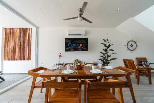 a dining room with a wooden table and chairs at Casa Arena mia, Chicxulub by Casago in Chicxulub