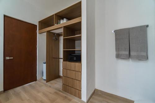 a room with a closet with a door and a hallway at Casa Arena mia, Chicxulub by Casago in Chicxulub