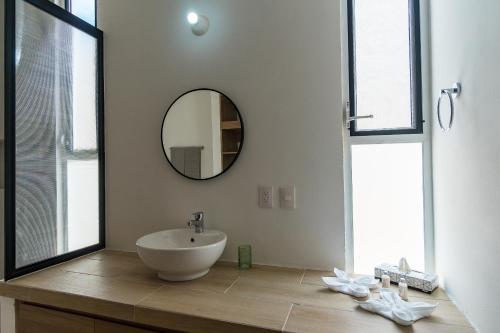 a bathroom with a sink and a mirror at Casa Arena mia, Chicxulub by Casago in Chicxulub
