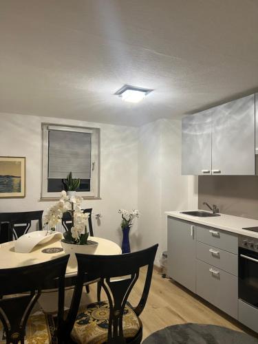 a kitchen with a table and chairs in a room at Kiefern Apartments in Hannover