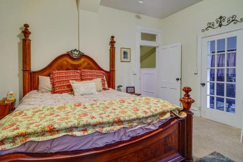 a bedroom with a large bed with a wooden headboard at Charming Ogden Vacation Rental 2 Mi to Downtown in Ogden