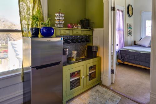 a kitchen with a refrigerator and a room with a bed at Charming Ogden Vacation Rental 2 Mi to Downtown in Ogden