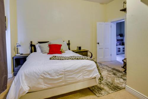 a bedroom with a large white bed with red pillows at Charming Ogden Vacation Rental 2 Mi to Downtown in Ogden