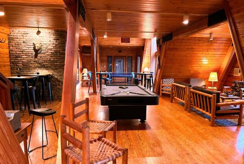 a room with a pool table in the middle of a room at NewVida Preserve in Wilmington