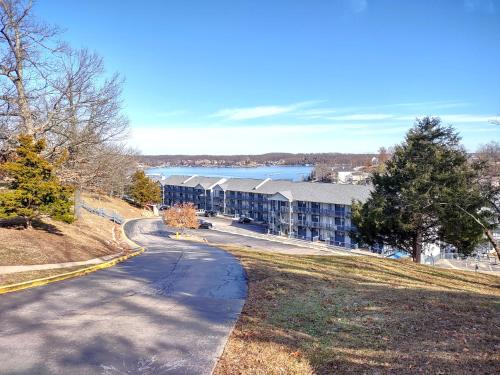 an empty road in front of a apartment building at B Lakefront! Remodeled, Boat Slip, Patio Views, Pool, Boat Ramp, WIFI in Osage Beach