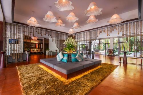 a large living room with a couch on a rug at Lotus Blanc Resort in Siem Reap