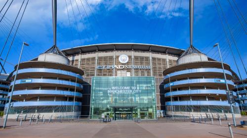 a large building in front of a stadium at Cosy Home in Manchester in Manchester