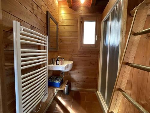 a bathroom with wooden walls and a sink and a window at Chalet de charme 8 pers avec parking, cheminée et terrasse - Saint-Martin-de-Belleville - FR-1-452-35 in Saint-Martin-de-Belleville