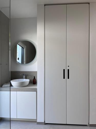 a white bathroom with a sink and a mirror at Ferien.Wohnung.Sartoris in Bad Neuenahr-Ahrweiler