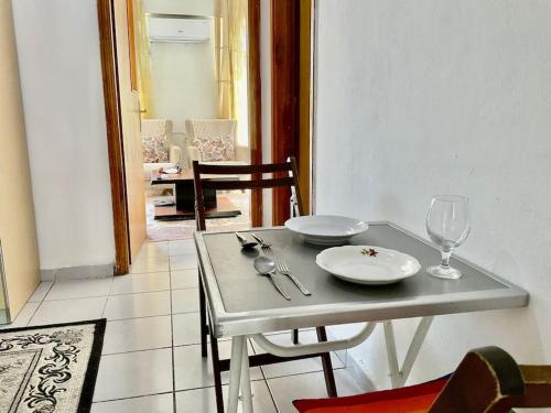 a table with a plate and wine glass on it at *Downtown* Furnished Flat [Mounthly Discount] D3 in Antalya