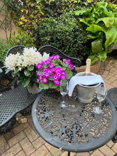 a table with wine glasses and flowers on a bench at The Swallow Hotel in Bridlington